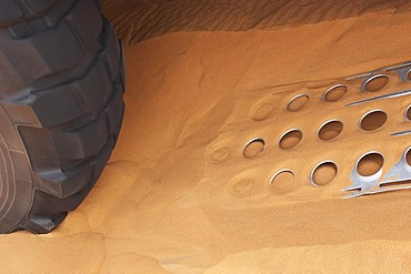 Tire and metal plates for sand in use