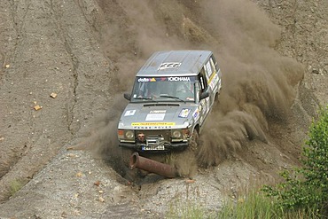 Range Rover 4x4 car dives with speed against a steel pipe or steel tube