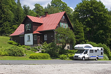 Motorhome in front of residential house, NËcovy Domky, Jizera Mountains, Czech Republic