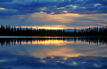 Sunset reflected on a lake in southeastern Alaska, USA