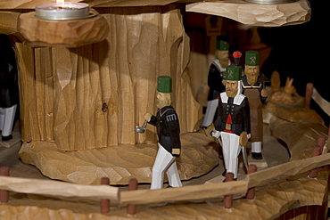 Hand carved miners in a christmas pyramid