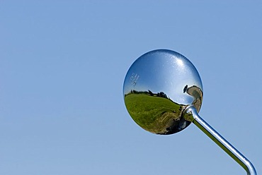 Rear view mirror of a motorcycle with landscape Bavaria Germany