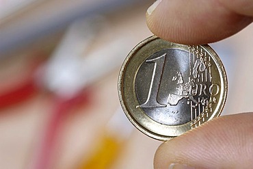 1 Euro coin in a hand