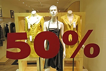 Boutique - shop window advertising - shop window with ladies` fashion - 50% discount.