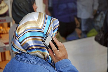 Woman with headscarf and mobile phone, Urfa, Anatolia, Turkey