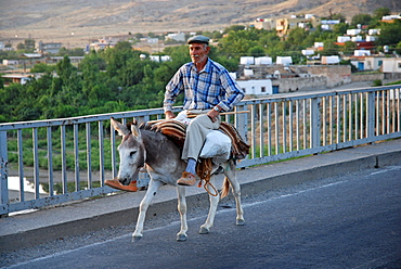 Kurdish man riding a donkey, Hasankeyf, southeastern Anatolia, Turkey, Asia