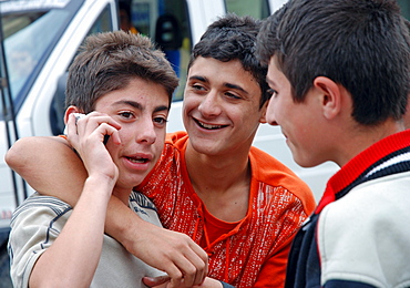 Boys talking on a mobile phone, Yusufeli, Kackar Mountains, northeastern Anatolia, Turkey, Asia