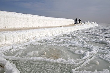 People walking on icy pier, frozen Black Sea, a rare phenomenon, last time it occured in 1977, Odessa, Ukraine, Eastern Europe