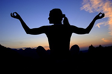 Woman doing yoga in the evening, Kalk Alps National Park, Upper Austria, Austria, Europe