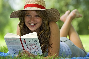 A woman reading a book outdoors