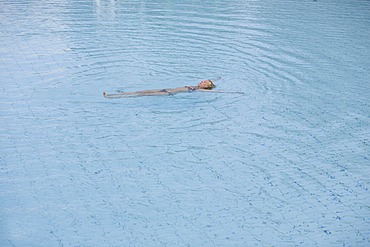 Blond woman swimming in the water