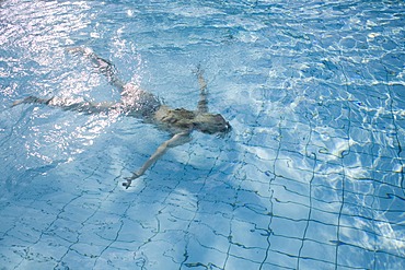 Blond woman swimming in the water