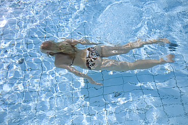 Blond woman swimming in the water