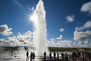 Tourists watching steam and a water spout, Strokkur geyser, backlit, Haukadalur valley, Golden Circle, Suâˆšâˆžurland, Sudurland, southern Iceland, Iceland, Europe