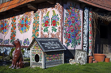 Blue window, traditional old wooden farm and kennel painted with colorful flowers, village Zalipie, near Tarnow, Lesser Poland, Poland, Europe