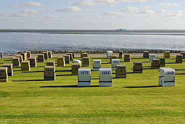 Roofed wicker beach chairs standing on a lawn, beach, Buesum, district of Dithmarschen, Schleswig-Holstein, North Sea, Wadden Sea, Germany, Europe, PublicGround