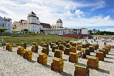 Roofed wicker beach chairs on the beach in front of the Kurhaus spa building, Binz, Mecklenburg-Western Pomerania, Germany