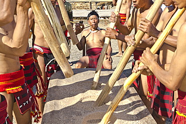 Members of the Samdom tribe show their traditional way of crushing crops at the annual Hornbill Festival, Kohima, Nagaland, India, Asia