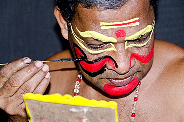 The make-up of the Kathakali character Nakrathundi is being applied, Varkala, Kerala, India, Asia