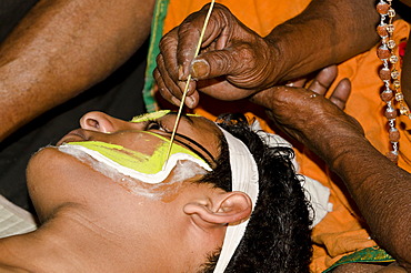 The make-up of the Kathakali character Krishna is being applied, Perattil, Kerala, India, Asia