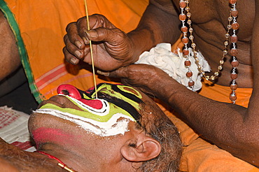 The make-up of the Kathakali character Ravana is being applied, Perattil, Kerala, India, Asia