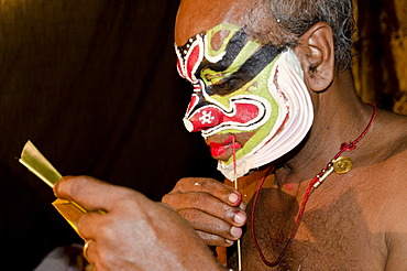 The make-up of the Kathakali character Ravana is being applied, Perattil, Kerala, India, Asia