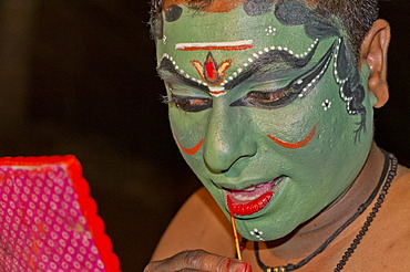 The make-up of the Kathakali character Kathalastri is being applied, Perattil, Kerala, India, Asia