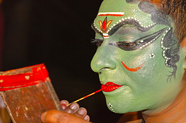 The make-up of the Kathakali character Kathalastri is being applied, Perattil, Kerala, India, Asia