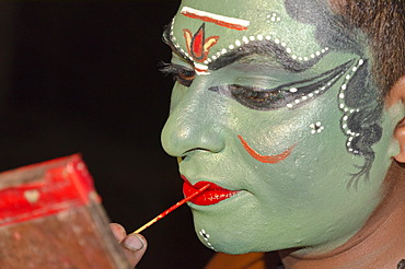 The make-up of the Kathakali character Kathalastri is being applied, Perattil, Kerala, India, Asia