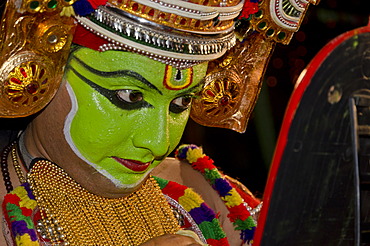 The Kathakali character Ottanthullal checking his make up, Perattil, Kerala, India, Asia