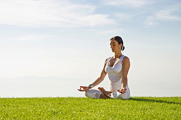 Young woman practising Hatha yoga outdoors, showing the pose padmasana, lotus pose, Nove Mesto, Okres Teplice, Czech Republic, Europe