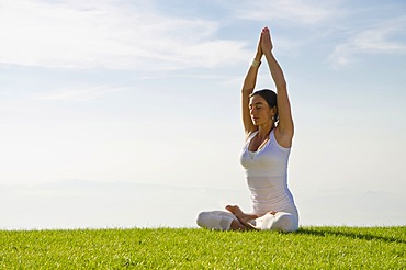 Young woman practising Hatha yoga outdoors, showing the pose merudandasana, sitting mountain pose, Nove Mesto, Okres Teplice, Czech Republic, Europe