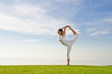 Young woman practising Hatha yoga outdoors, showing the pose natarajasana, Lord Shiva's pose, Nove Mesto, Okres Teplice, Czech Republic, Europe