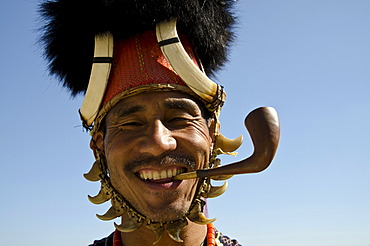 Warrior of the Konyak tribe waiting to perform ritual dances at the Hornbill Festival, Kohima, Nagaland, India, Asia