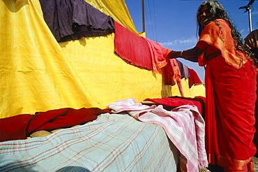 Woman drying laundry in the hot winds of Varanasi, Uttar Pradesh, India, Asia