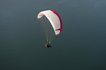 Paragliding, paraglider flying over Lake Garda, Veneto, Italy