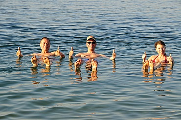 Tourists, thumbs-up, in the Dead Sea near Suwaymah, Jordan, Middle East, Orient