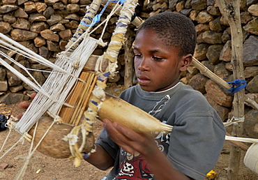 Boy working on a loom in the village of Rhumsiki, Cameroon, Central Africa, Africa