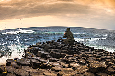 Man taking photo with a smartphone, Giant's Causeway, basalt columns, Causeway Coast, County Antrim, Northern Ireland, United Kingdom, Europe