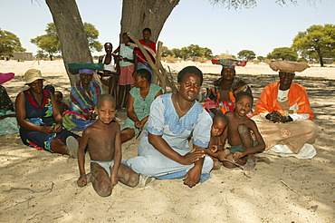 Locals sitting under village tree, Sehitwa, Botswana, Africa