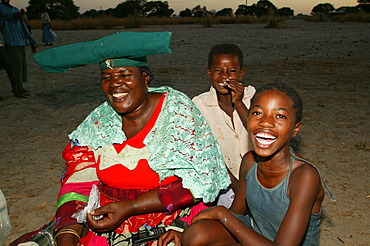 Women of the community gathering under the village tree, Sehitwa, Botswana, Africa