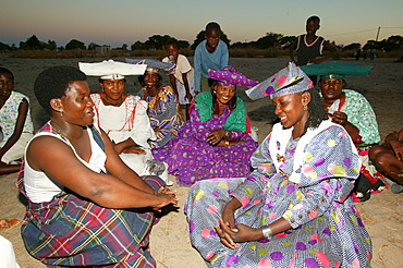 Women of the community gathering under the village tree, Sehitwa, Botswana, Africa