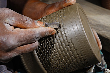 Decoration of a clay pot with ornaments, manufacture of pottery, Bamessing, Cameroon, Africa