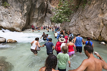 Tourists walking in the water of the gorge, Saklikent Gorge near Tlos and Fethiye, Lycian coast, Lycia, Mediterranean, Turkey, Asia Minor