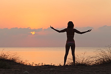 Woman meditating on the Mediterranean Sea at sunrise, Aegean, Lycian coast, Lycia, Turkey, Asia Minor