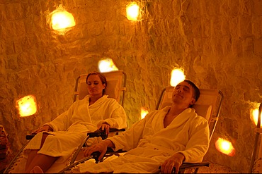 Woman and man relaxing in salt cave