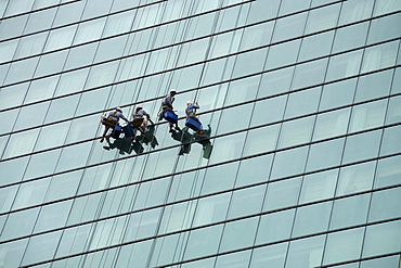 Window cleaners on a modern glass facade in Saigon, Ho Chi Minh City, Vietnam, Southeast Asia