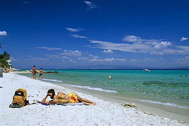 Woman sunbathing on a beach, Afithos, Kassandra, Chalkidiki, Greece, Europe