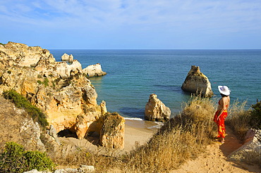 Woman with a view to Paria dos Tres Irmaos, Algarve, Portugal, Europe