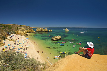 Woman overlooking Praia Dona Ana near Lagos, Algarve, Portugal, Europe